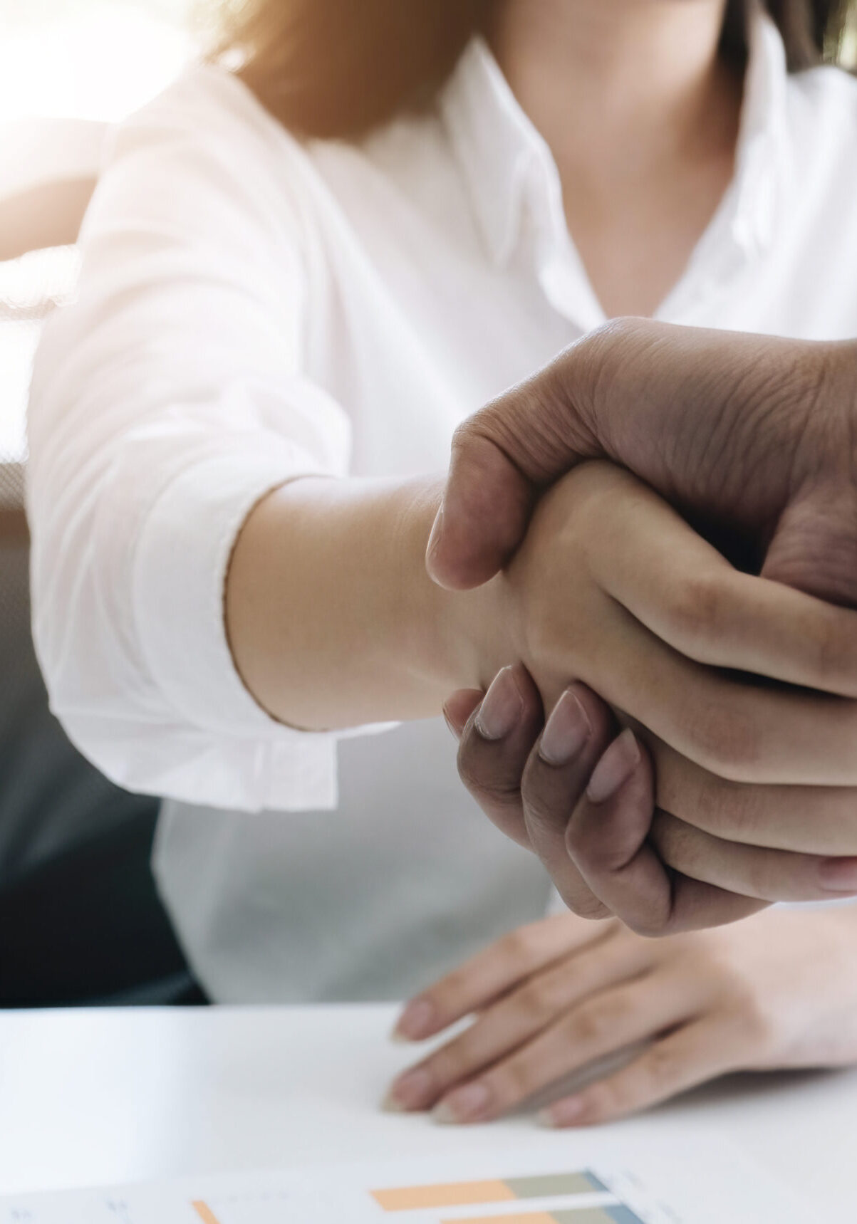 A close-up picture of a business shaking hands on a business cooperation agreement in the office. Concept of Cooperation business and success